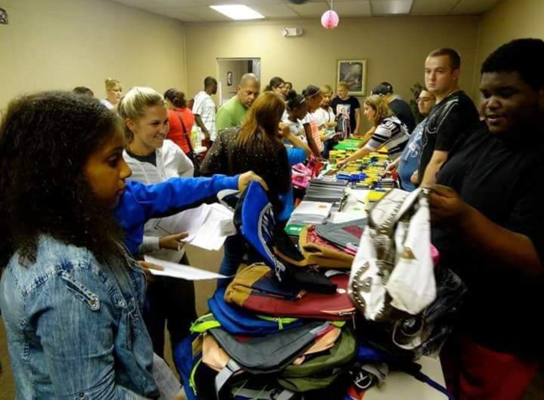 Students in the William Floyd School District collect backpacks and school supplies raised by the King’s Kids Christian Outreach at the Evangel Temple Church on Neighborhood Road in Mastic Beach last year.